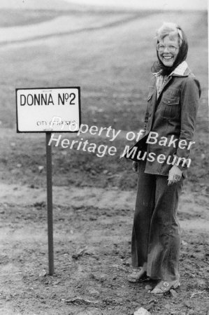 Woman standing by a sign in Ha