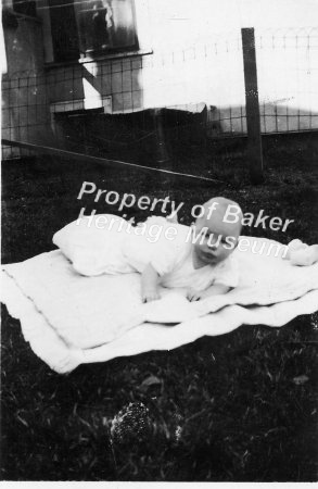 Baby on blanket in yard