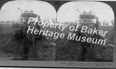 Digging ditch with tractor, and laying drain tile, Wisconsin