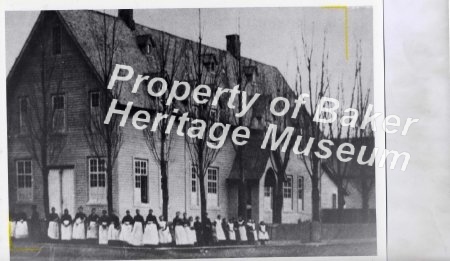 Women standing outside a schoo