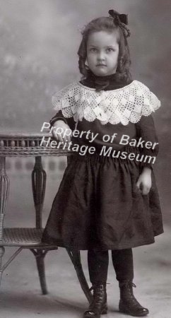 Girl standing next to a table