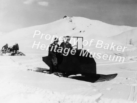 2 men in snow machine