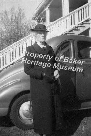 elderly woman by car