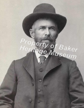 Man in suit with hat and beard