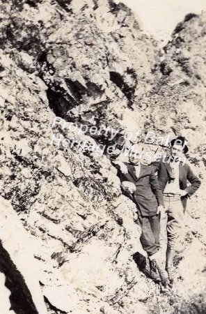 Two men posing with rocks