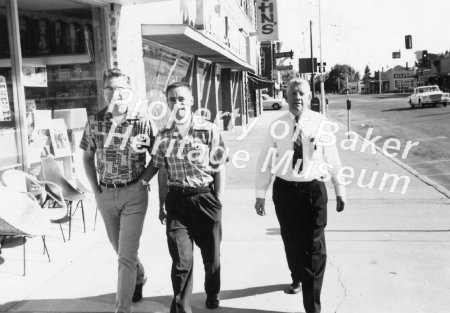 3 men walking on Main Street