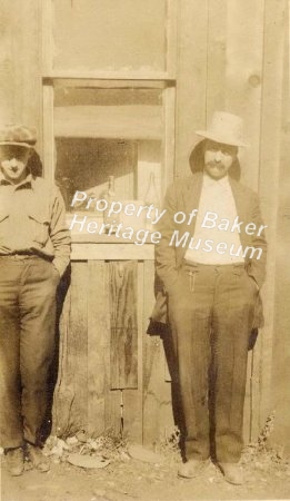 Two men standing by a window