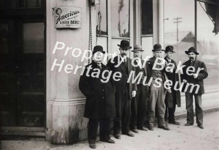 Men on street in front of Bar